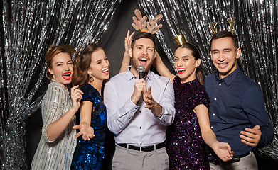 Image showing friends with microphone singing at christmas party