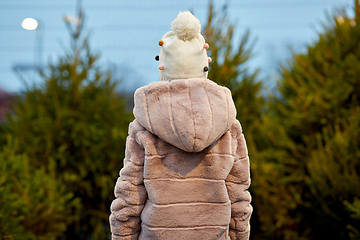 Image showing little girl choosing christmas tree at market