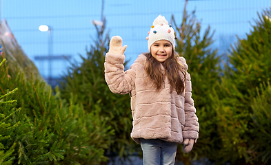 Image showing little girl waving hand at christmas tree market