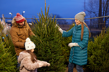 Image showing happy family choosing christmas tree at market