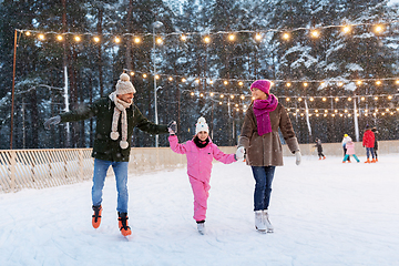 Image showing happy family at outdoor skating rink in winter