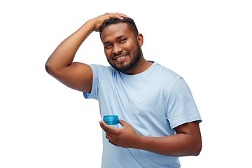 Image showing african american man applying hair styling wax