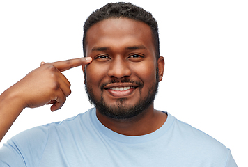 Image showing african american man pointing finger to his eye