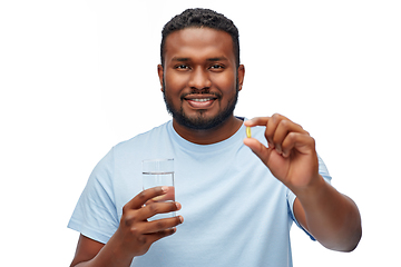 Image showing african american man with pill and glass of water