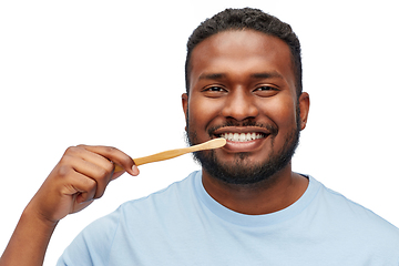 Image showing smiling african man with toothbrush cleaning teeth