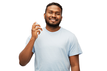 Image showing happy african american man with perfume