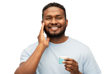 Image showing happy african man applying wax to his beard