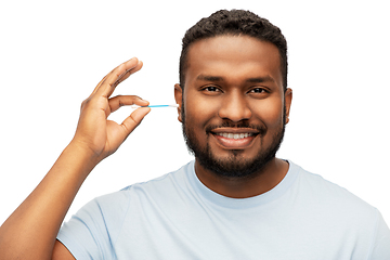 Image showing african american man cleaning ear with cotton swab
