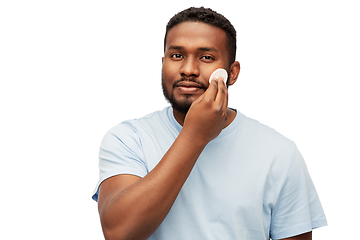 Image showing african american man cleaning face with cotton pad