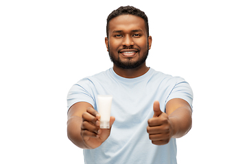 Image showing african man with moisturizer showing thumbs up