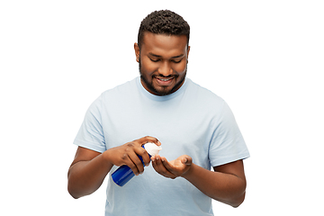 Image showing happy african man applying shaving foam to hand