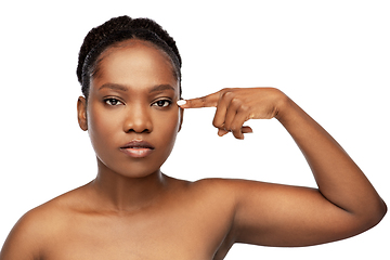 Image showing beautiful african woman pointing to her eye