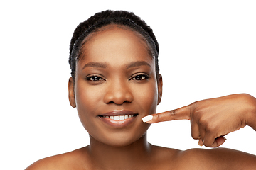 Image showing african american woman pointing to her mouth