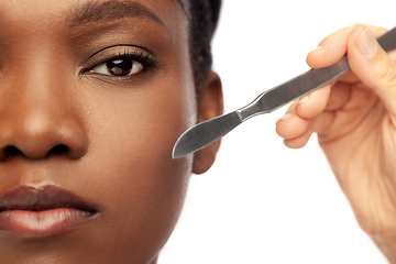 Image showing face of african american woman and scalpel knife