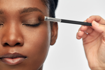 Image showing face of african woman and hand with make up brush