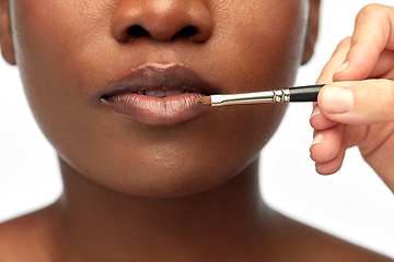 Image showing face of african woman and hand with make up brush