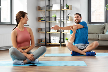 Image showing happy couple exercising at home