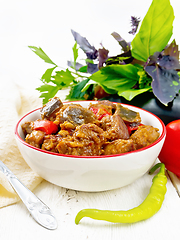 Image showing Meat with eggplant and pepper in bowl on white board