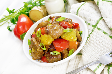 Image showing Meat with oranges in bowl on white board