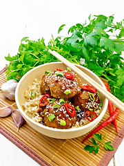 Image showing Meatballs in sweet and sour sauce with rice on white board