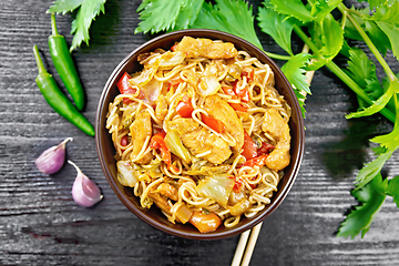 Image showing Noodles with cabbage and chicken in bowl on board top