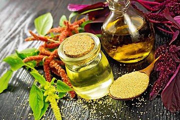 Image showing Oil amaranth in jar on wooden board