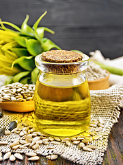 Image showing Oil sunflower in jar with flour on wooden board