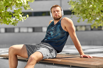 Image showing man in headphones listening to music outdoors