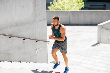 Image showing young man running upstairs