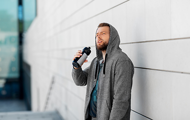 Image showing sportsman with bottle of water in city