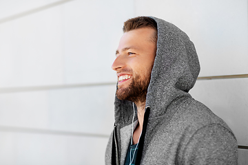 Image showing man in earphones listening to music outdoors