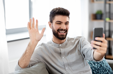 Image showing man with smartphone having video call at home