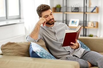 Image showing man reading book at home