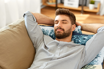 Image showing young man sleeping on sofa at home