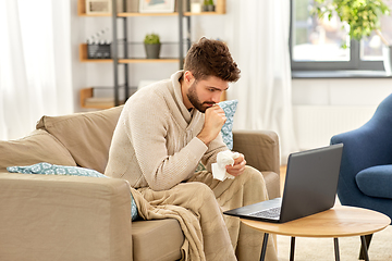 Image showing sick man having video call on laptop at home