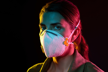 Image showing young woman wearing protective mask or respirator