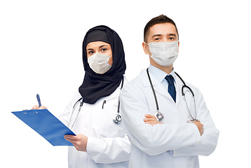 Image showing doctors in masks with clipboard and stethoscope