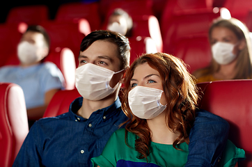 Image showing couple in masks watching movie in theater