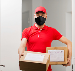 Image showing delivery man in mask with parcel boxes