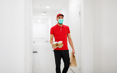 Image showing delivery man in mask with coffee and food