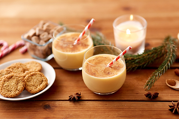 Image showing glasses of eggnog, oatmeal cookies and fir branch