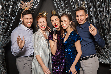 Image showing friends with microphone singing at christmas party