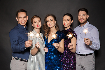 Image showing happy friends in party clothes with sparklers