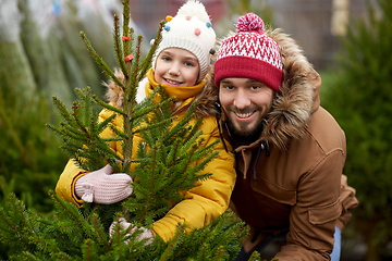 Image showing happy family choosing christmas tree at market