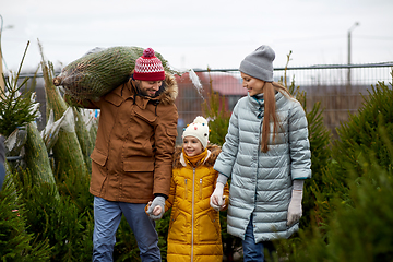 Image showing happy family buying christmas tree at market