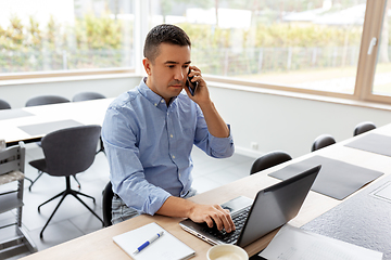 Image showing man calling on smartphone at home office