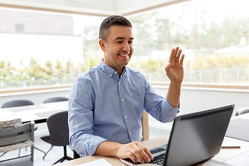 Image showing man with laptop having video call at home office