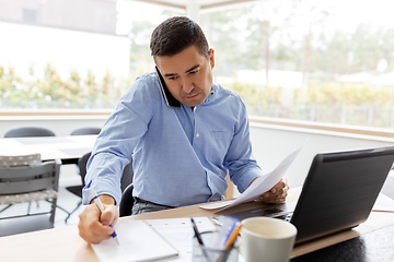 Image showing man calling on smartphone at home office