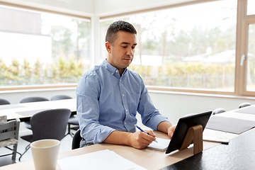 Image showing man with tablet computer working at home office