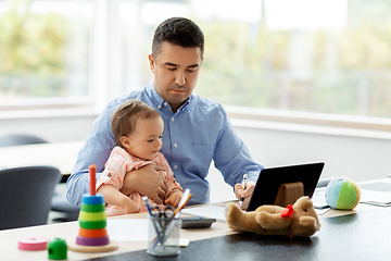 Image showing father with baby working at home